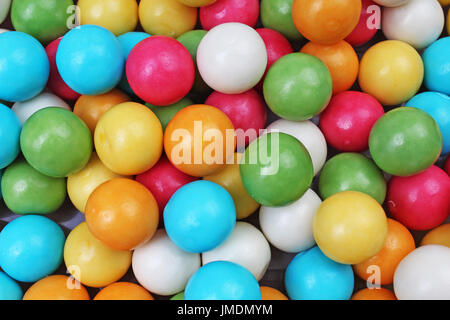 Bubble gum chewing gum texture. Rainbow multicolored gumballs chewing gums as background. Round sugar coated candy dragee bubblegum texture. Food cute Stock Photo