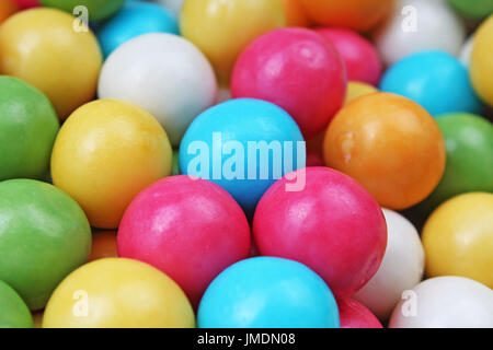 Bubble gum chewing gum texture. Rainbow multicolored gumballs chewing gums as background. Round sugar coated candy dragee bubblegum texture. Food cute Stock Photo