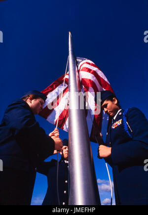 US flag raising ceremony performed by US Air Force ROTC - reserve officer training corps - high school cadets in uniform outside their high school Stock Photo