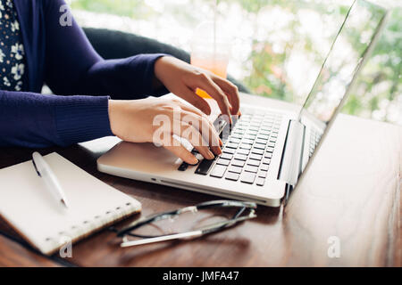 Cropped image of young woman working at home, small office Stock Photo