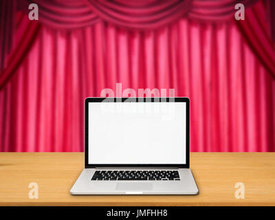 blank screen notebook on stage with red curtain background Stock Photo