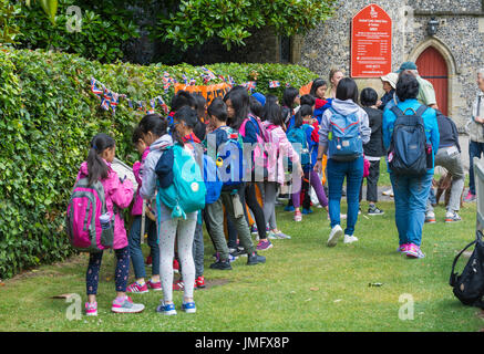 Group of young Japanese school children on a trip to England, UK, visiting a castle. Young tourists. Stock Photo