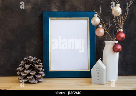 Christmas, New Yera blue and golden frame mockup with blank space for text, artwork, colorful baubles, house candle, pine cones, minimalist style, sca Stock Photo