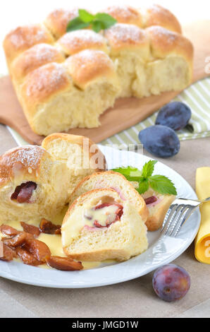Sweet Austrian yeast pastry dumplings stuffed with plums and served with vanilla sauce Stock Photo