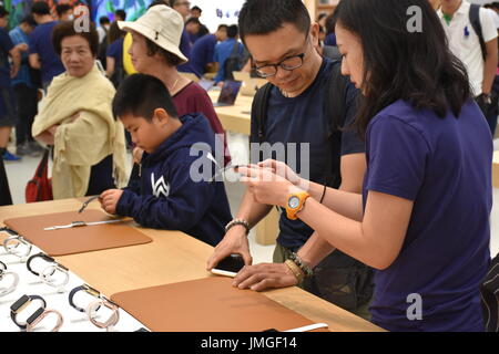 A man learns about iwatch and iPhone at the grand opening of the 1st Apple headquarters located in Taipei 101 building, Taipei, Taiwan. Stock Photo