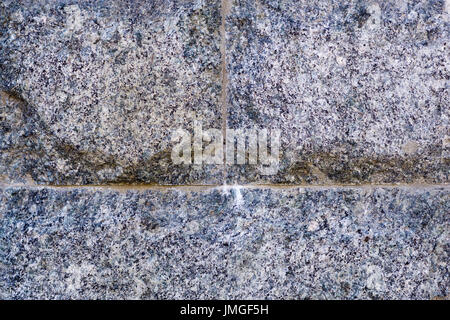 Wall texture of tiled granite stone bricks Stock Photo