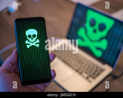 Virus on both computer and smart phone. Stock Photo