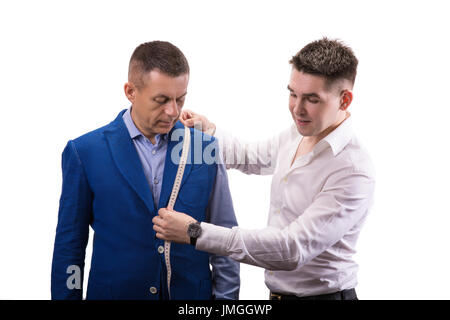 Portrait of handsome man during model fitting of tailored suit in atelier isolated on white background Stock Photo