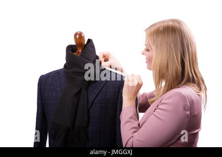 Freelancer - Fashion designer or Tailor working on a design or draft, she takes measure on a dressmakers dummy isolated on white background Stock Photo