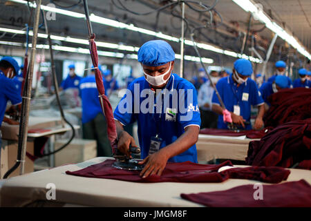 Workers in an iron section of a ready-made garment factory at ...