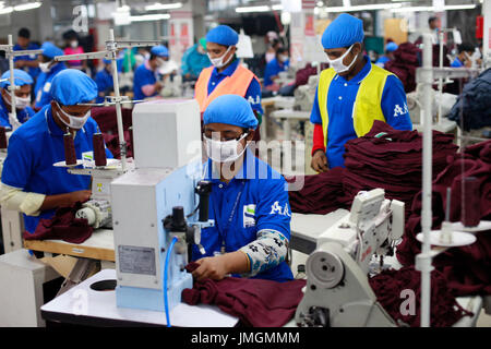 Female workers in a sewing section of a ready-made garment factory at Narayanganj on the outskirts of Dhaka, Bangladesh on June 21, 2014. Bangladesh i Stock Photo