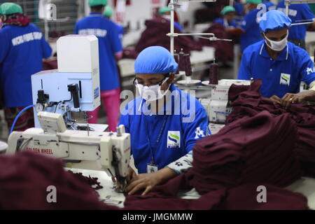 Female workers in a sewing section of a ready-made garment factory at Narayanganj on the outskirts of Dhaka, Bangladesh on June 21, 2014. Bangladesh i Stock Photo