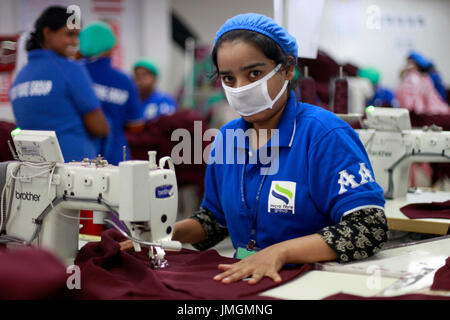 Female workers in a sewing section of a ready-made garment factory at Narayanganj on the outskirts of Dhaka, Bangladesh on June 21, 2014. Bangladesh i Stock Photo