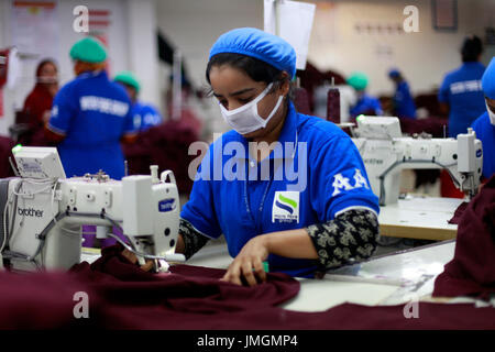 Female workers in a sewing section of a ready-made garment factory at Narayanganj on the outskirts of Dhaka, Bangladesh on June 21, 2014. Bangladesh i Stock Photo