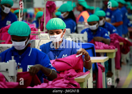 Workers in a sewing section of a ready-made garment factory in Gazipur on the outskirts of Dhaka, Bangladesh on June 22, 2014. Bangladesh is the secon Stock Photo