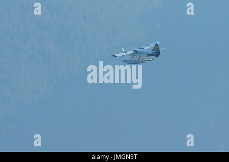 Harbour Air Seaplanes Turbo Otter Floatplane Flying Over Remote Woodlands In British Columbia, Canada. Stock Photo