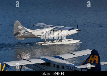 Harbour Air Seaplanes Turbo Otter Floatplane In The Fairmont Hotels Livery, Taxiing In Vancouver Harbour, British Columbia,Canada. Stock Photo