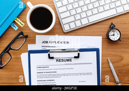 Resume and job application on work desk for job search concept Stock Photo