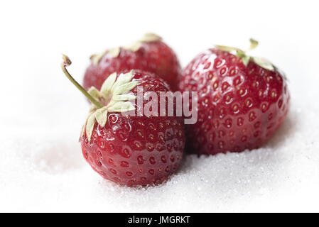 Image of sweet strawberry isolated over white sugar background. Stock Photo