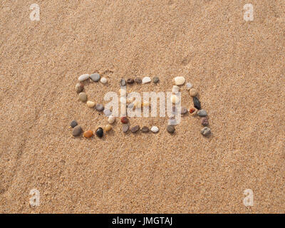 word sea written with stones and shells on the beach by the ocean Stock Photo