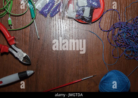 tailoring tools on brown wooden table. background, border. Stock Photo