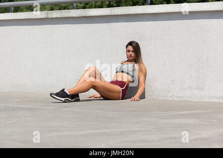 Attractive motivated young healthy fitness woman wearing sports bra and  shorts isolated over black background, running Stock Photo - Alamy