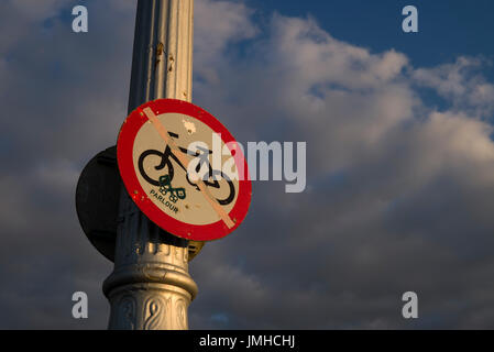 Old warning sign on lampost Stock Photo