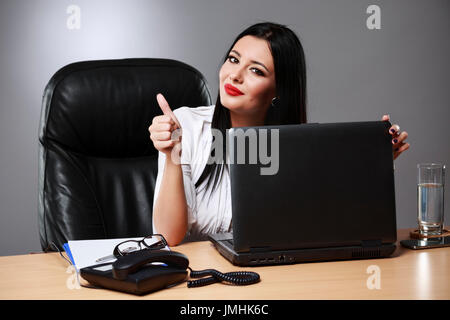 Happy businesswoman shows thumbs up. Stock Photo