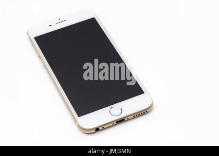 Gold white Apple iPhone 6 6s with blank black display lying isolated on white background Stock Photo