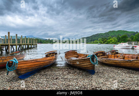 Wooden boats on the shores of Lake Windermere by the Ambleside Pier Stock Photo