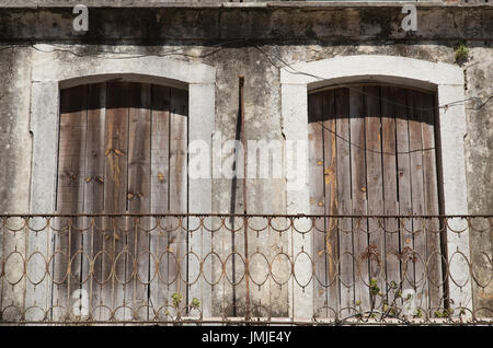 boarded up windows on an abandoned building in Lisbon Portugal Stock Photo