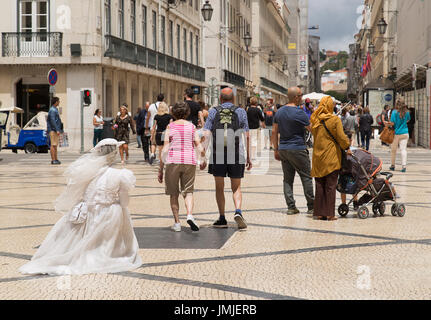 street entertainer dressed in wedding dress in Lisbon Portugal Stock Photo