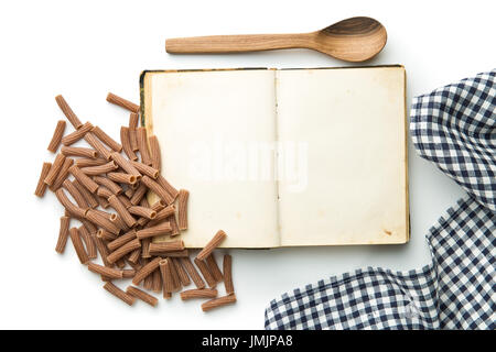 Blank recipe book and italian pasta isolated on white background. Top view. Stock Photo