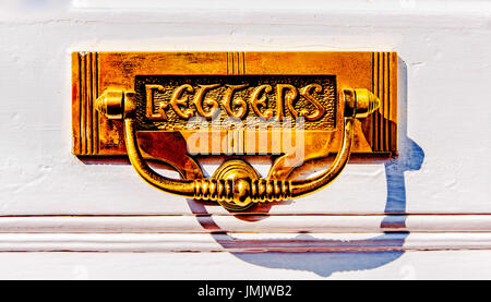 Letter box on a white door with the word 'Letters' written on it; briefkastenklappe an einer Eingangstür Stock Photo