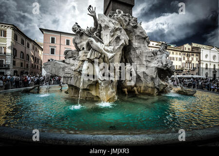 The Fountain of the Four Rivers by Bernini in the Piazza Navona in Rome Italy. The skies are dark with a storm coming. Stock Photo