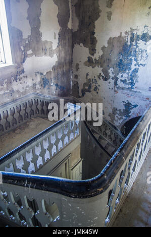 Spiral staircase in abandoned house Stock Photo