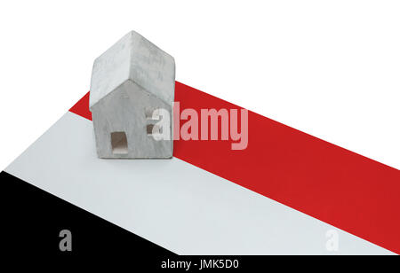Small house on a flag - Living or migrating to Yemen Stock Photo