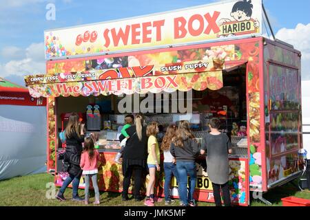people queuing  in front of a mobile sweet van at a show Stock Photo