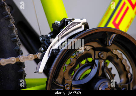 Tambov, Russian Federation - May 07, 2017 Close-up of Shimano Tourney front derailleur on bicycle chainwheel. Stock Photo