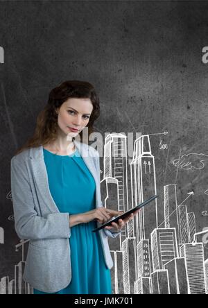 Digital composite of Business woman using a tablet against grey background with city icons Stock Photo