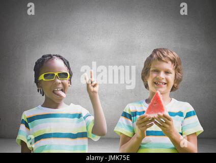 Digital composite of Boys with watermelon and sunglasses in front of grey background Stock Photo