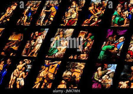 Milan, Italy - June 27, 2016: Close-up of colorful stained glass depicting religious scenes inside the Cathedral (Duomo) in Milan, Italy Stock Photo