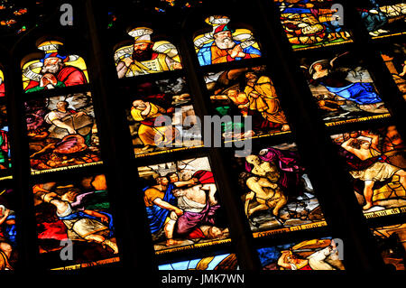 Milan, Italy - June 27, 2016: Close-up of colorful stained glass depicting religious scenes inside the Cathedral (Duomo) in Milan, Italy Stock Photo