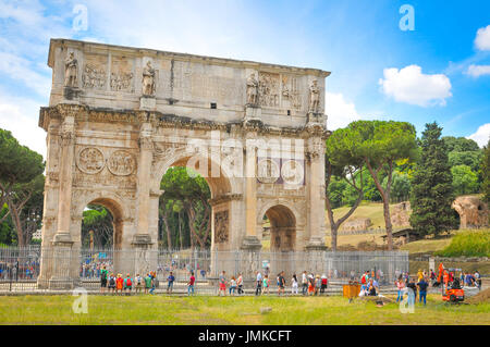 Rome, Italy - June 19, 2016: Tourists visit the Roman vestiges of the Arch of Constantine, major touristic attraction in Rome, Italy Stock Photo