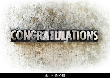 The word 'CONGRATULATIONS' written in old vintage letterpress type. Stock Photo
