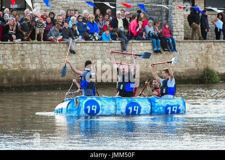 West Bay, Dorset, UK.  27th July 2017.  Annual RNLI Raft Race on the River Brit at the seaside resort of  West Bay in Dorset.  The winning team celebrate victory.  Picture Credit: Graham Hunt/Alamy Live News Stock Photo