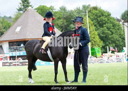 Llanelwedd, Powys, UK. 27th July, 2017. Seven-year-old Ella Eyenon takes reserve prize in the 'Supreme Champion Ridden Horse' event on the last day of the Royal Welsh Show. The Royal Welsh Agricultural Show is hailed as the largest & most prestigious event of its kind in Europe. In excess of 200,000 visitors arrive for the four day show period. The first ever show was at Aberystwyth in 1904 and attracted 442 livestock entries. Credit: Graham M. Lawrence/Alamy Live News