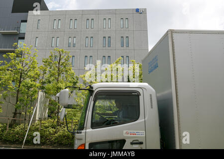 A Sagawa Express delivery truck drives past the Sagawa headquarters on July 28, 2017, Tokyo, Japan. Sagawa Express Co. expects to increase its delivery charges from November 21st due to the increasing demand from online shopping. The company said on Wednesday that its door to door service fee would rise 17.8 percent on average. Competitor Yamato Transport Co. also plans to raise rates in October. Credit: Rodrigo Reyes Marin/AFLO/Alamy Live News Stock Photo