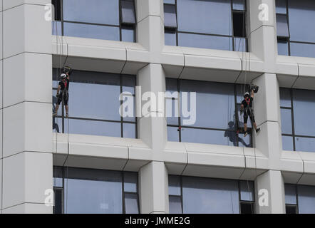 Haikou, China's Hainan Province. 28th July, 2017. People attend a high-rise building fire drill in Haikou, capital of south China's Hainan Province, July 28, 2017. Credit: Yang Guanyu/Xinhua/Alamy Live News Stock Photo