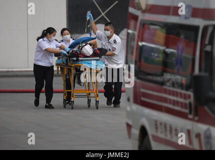 Haikou, China's Hainan Province. 28th July, 2017. People attend a high-rise building fire drill in Haikou, capital of south China's Hainan Province, July 28, 2017. Credit: Yang Guanyu/Xinhua/Alamy Live News Stock Photo